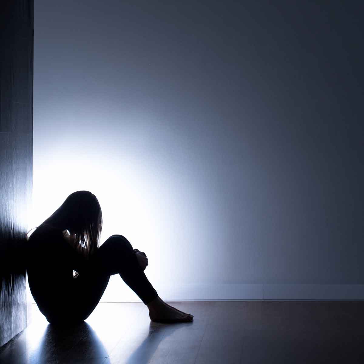 dark photo of girl sitting on the floor